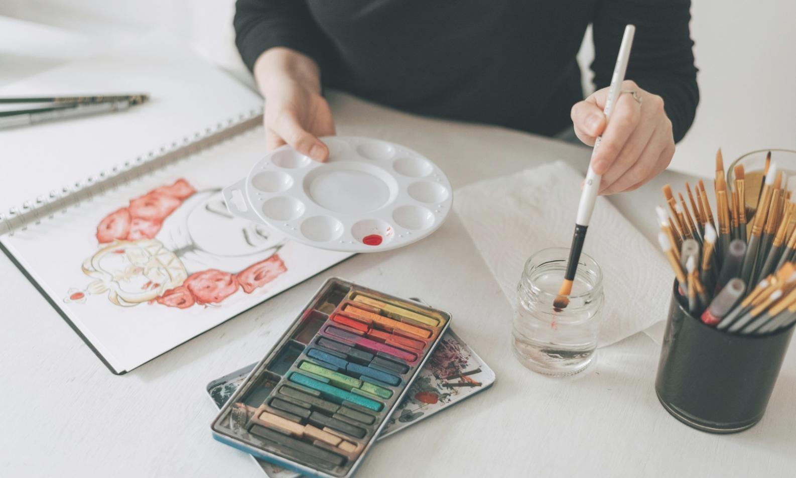 Student working on watercolor landscape technique