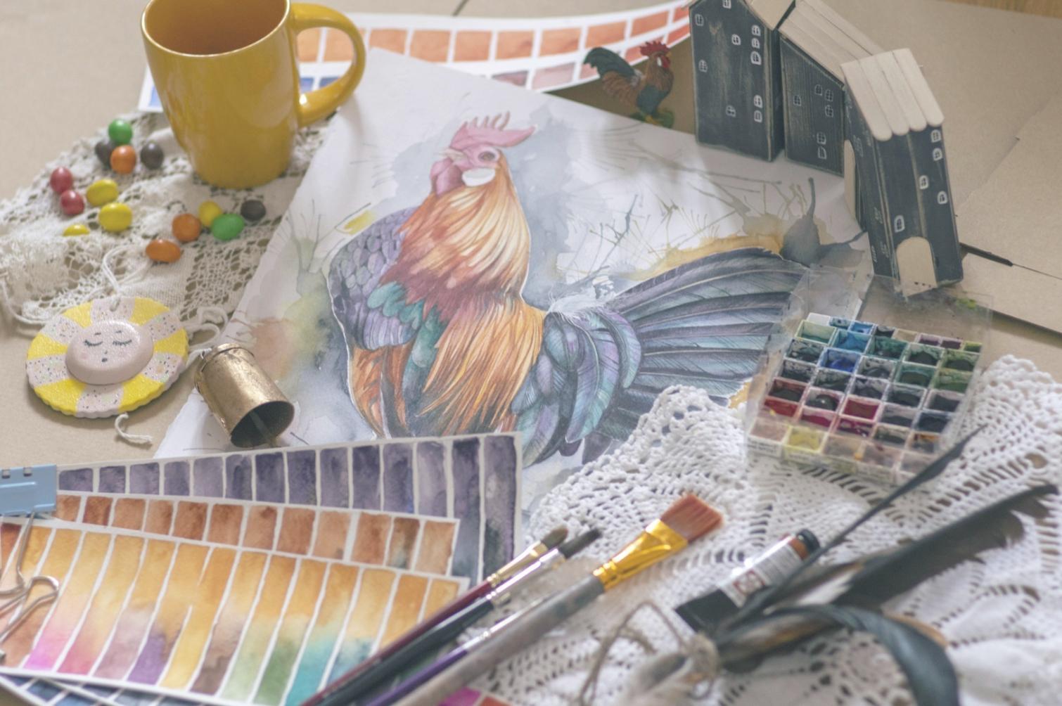 Watercolor illustration workspace with brushes and paint palette
